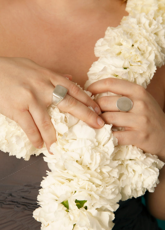 Anillo de plata 925 de sello ovalado y sello cuadrado. Foto modelo manos.
