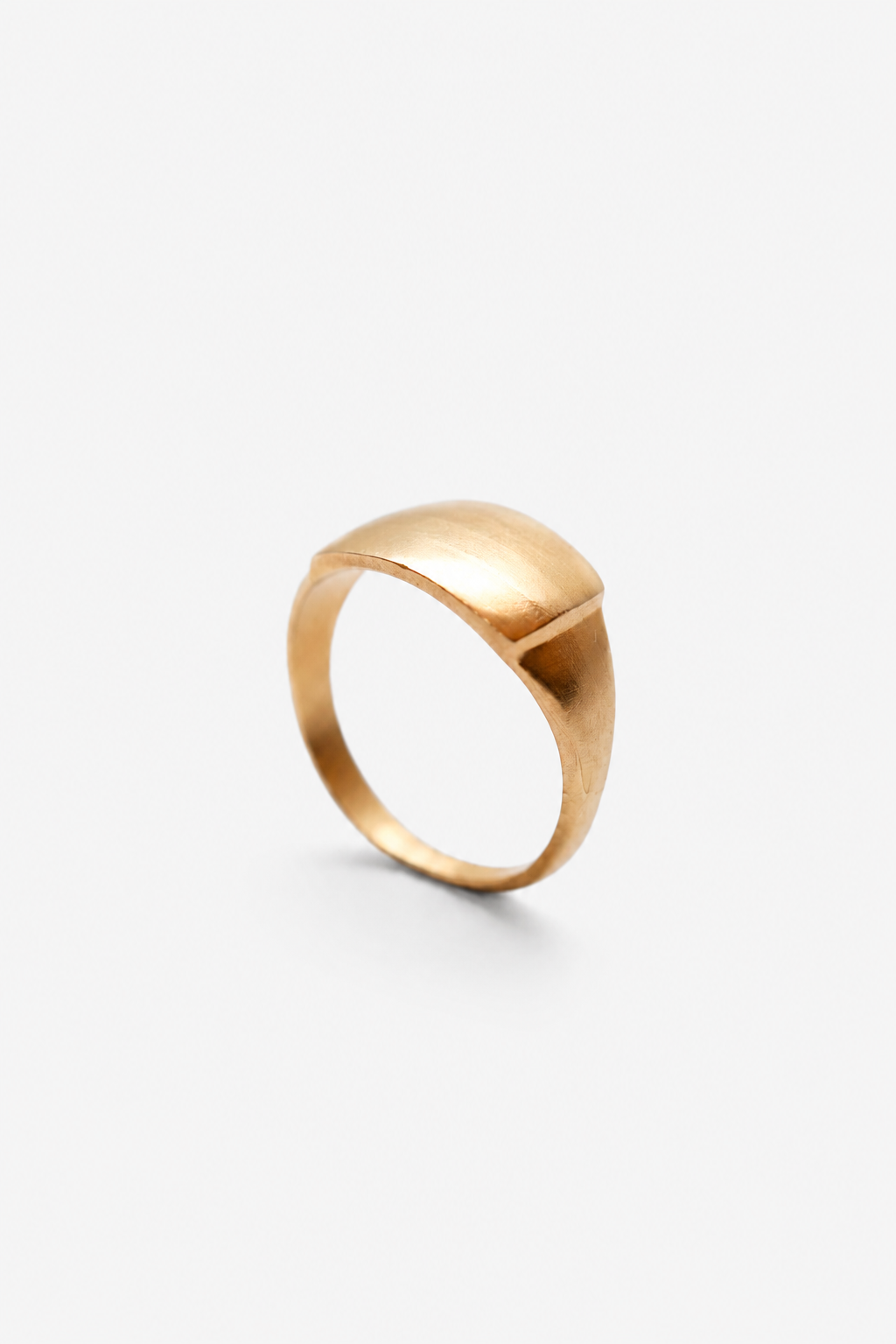 Anillo artesanal abombado hecho con plata maciza y moldeado en cera, bañado en oro. Foto detalle producto.