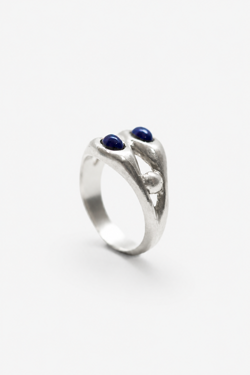 Anillo artesanal con granate azul clavado en plata. Foto detalle producto. 